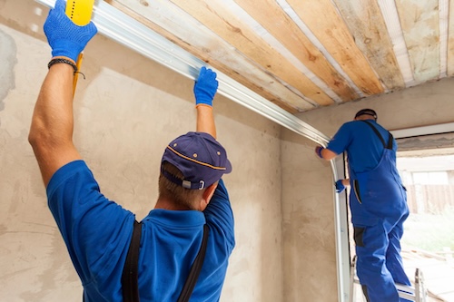 image of two installers working on a garage door