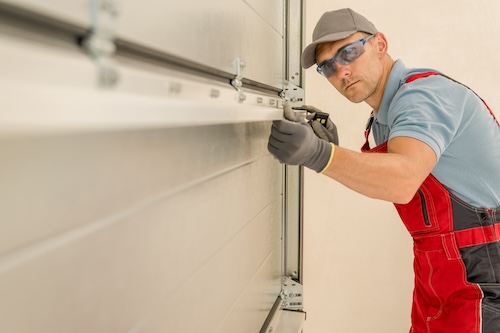 image of a solo operator checking a garage door.